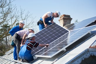 Solar professionals installing solar panels after company researched digital marketing strategies for solar companies