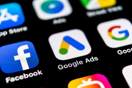 Paid search marketing agency looking at Google Ads on phone