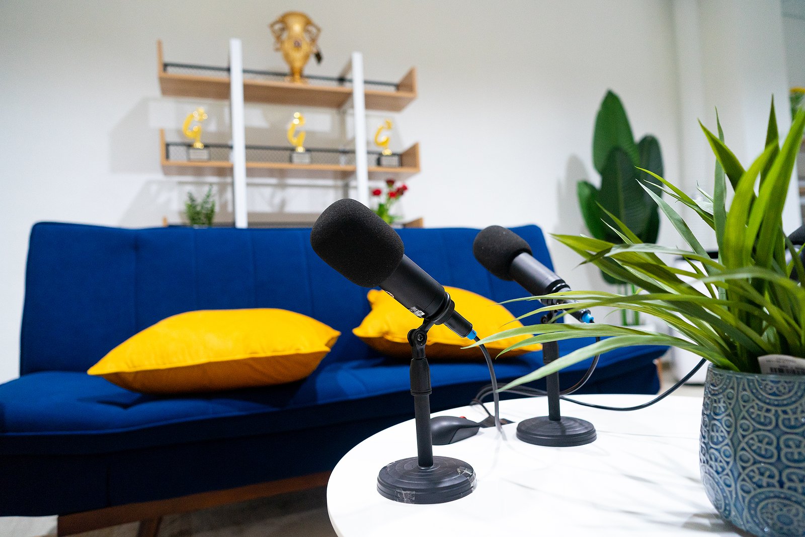 Microphones and colorful pillows and couch at Las Vegas podcast studio